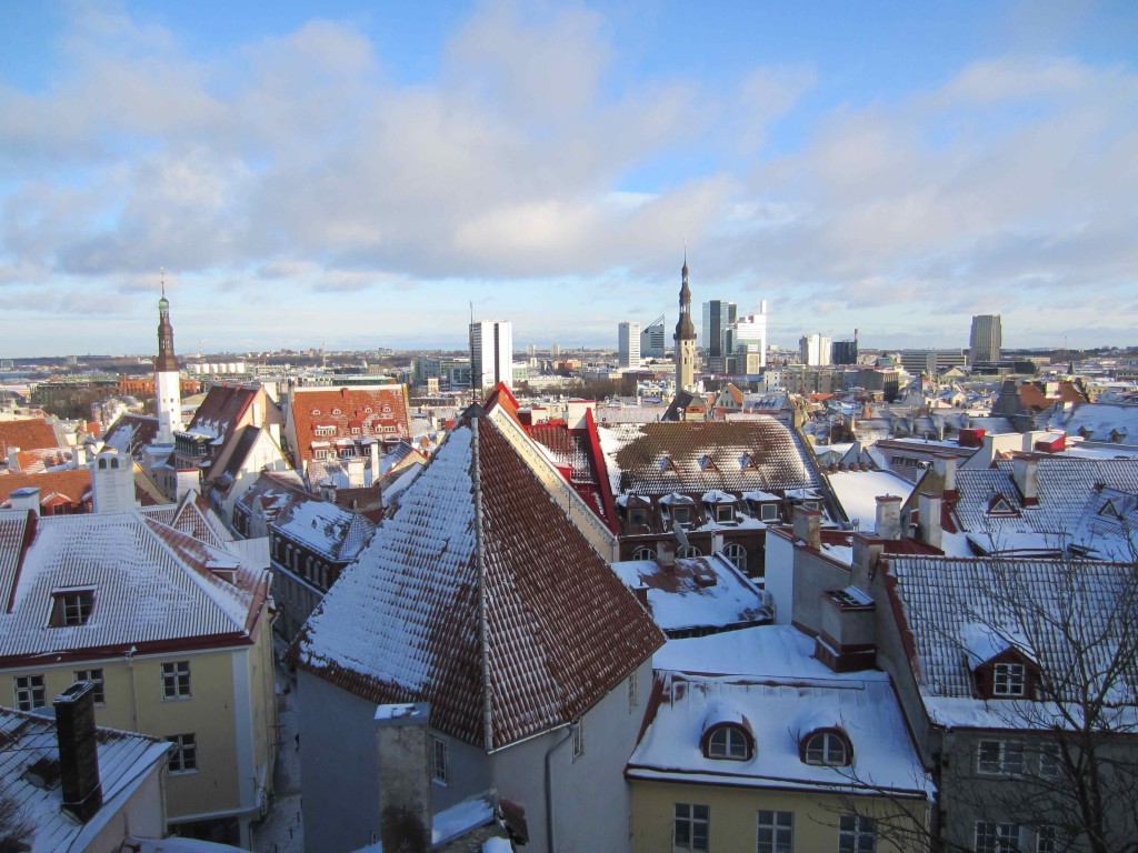 a city with snow on rooftops