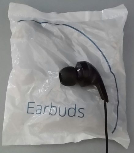 a black earbuds on a white plastic bag