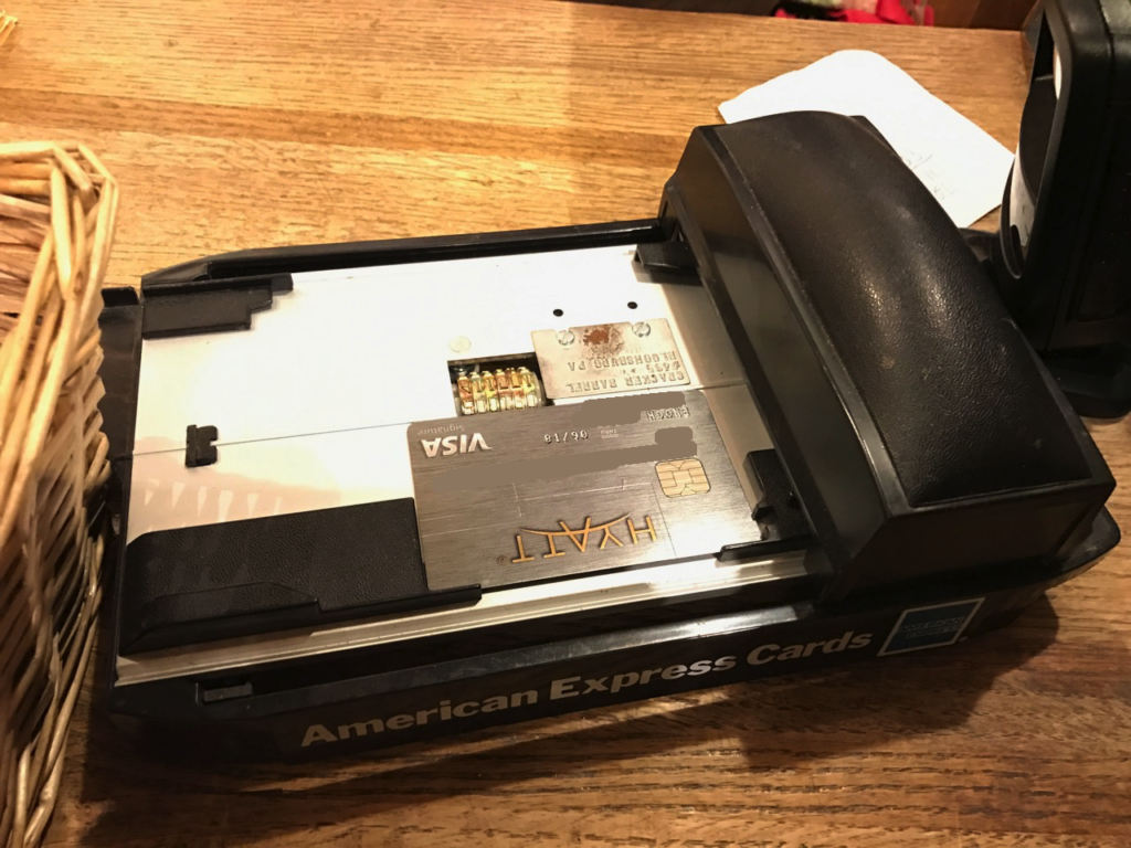 A credit card imprinter that can only "process" cards with embossed numbers.
