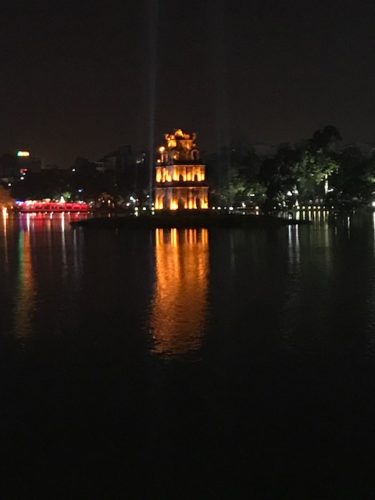 a building with lights on the water
