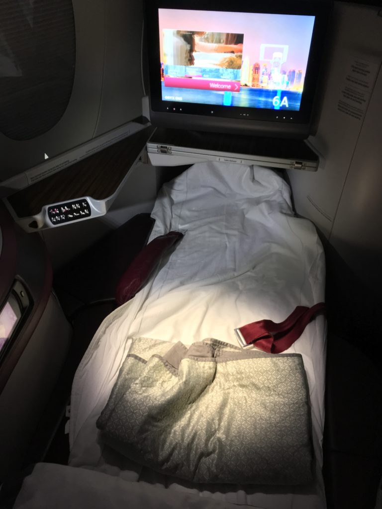 a bed with a tv in the back of it