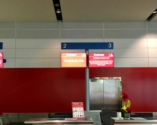 a red and white sign in a airport