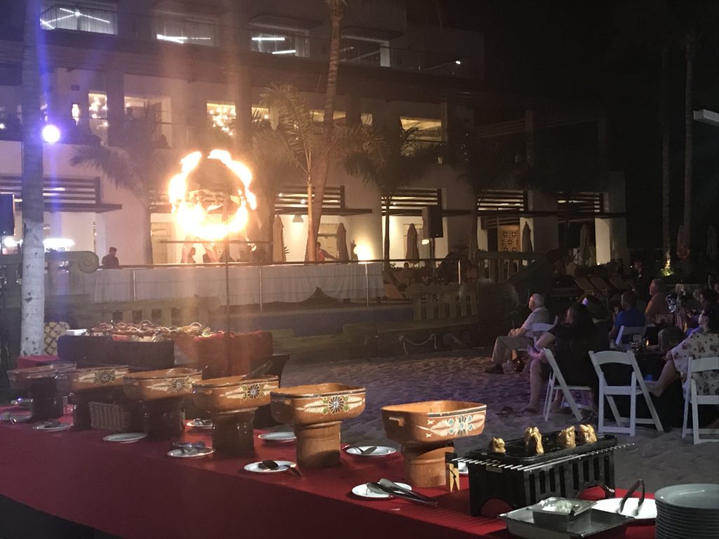 a table with food on it and a man on fire