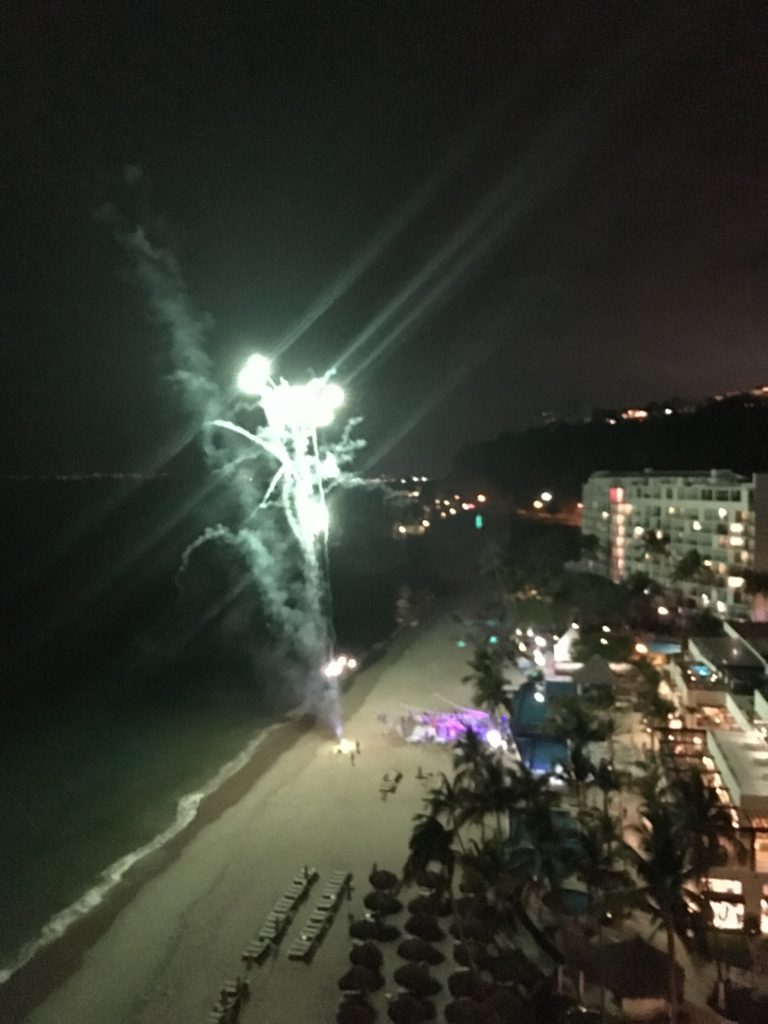 fireworks in the sky over a beach