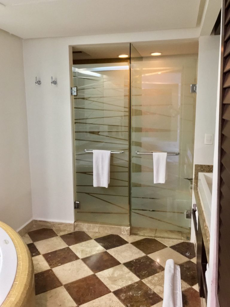 a bathroom with glass doors and a bathtub