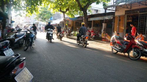 a group of people riding motorcycles on a street