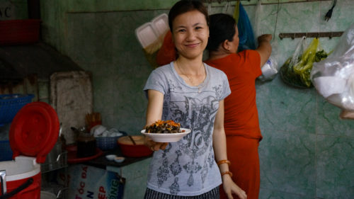 a woman holding a plate of food