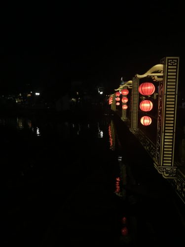 a row of lanterns on a bridge