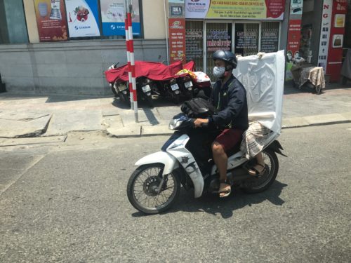 a man on a motorcycle wearing a face mask
