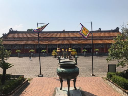 a large building with a pot in front of it