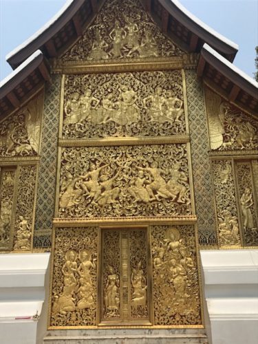a gold carved door on a building