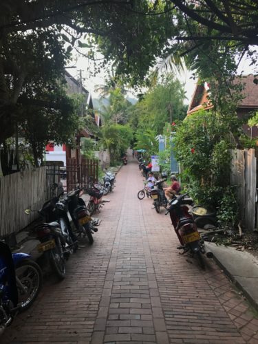 a brick path with motorcycles parked on it