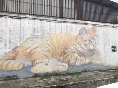 a painting of a cat on a wall