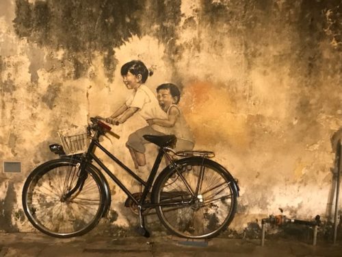a painting of two children on a bicycle