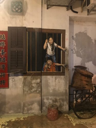a mural of two girls in a window