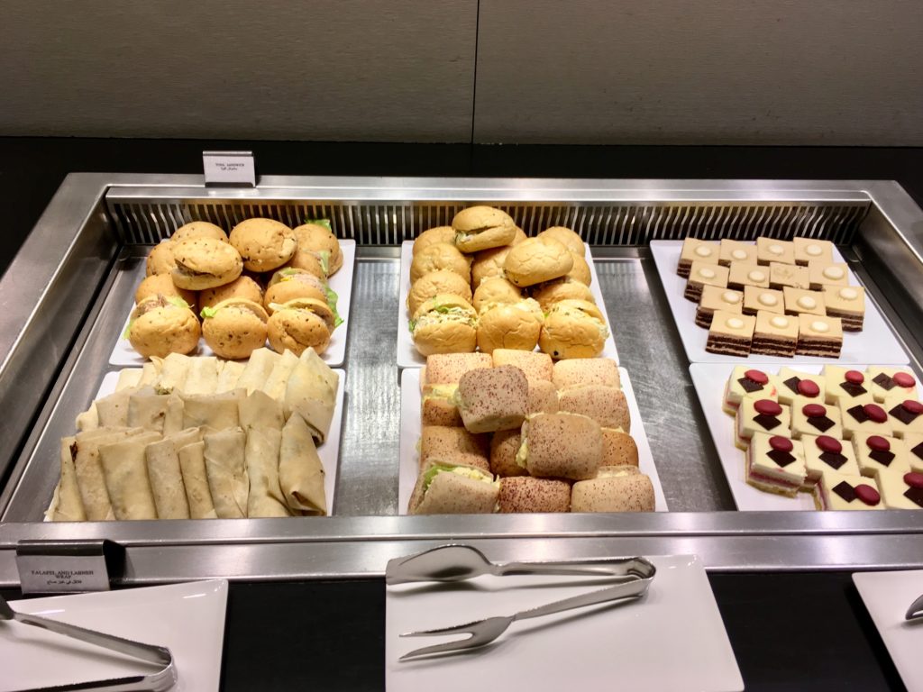 a tray of sandwiches and sandwiches on a counter