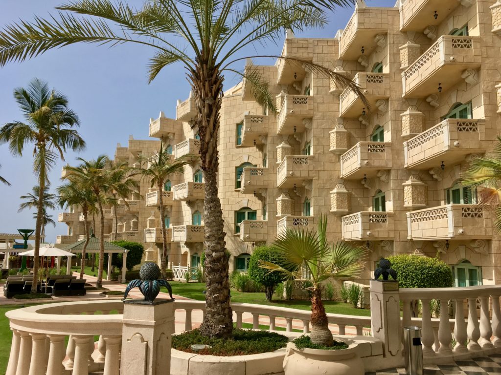 a building with palm trees and a palm tree