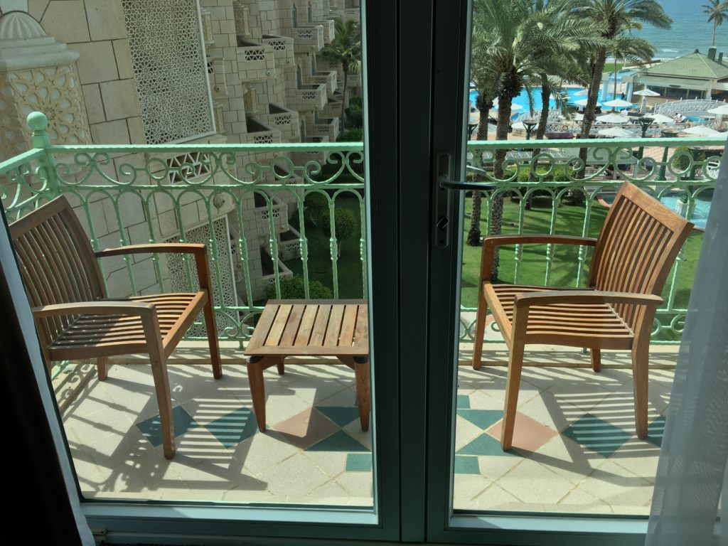 a two chairs on a balcony