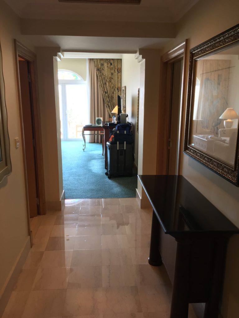 a hallway with a table and luggage