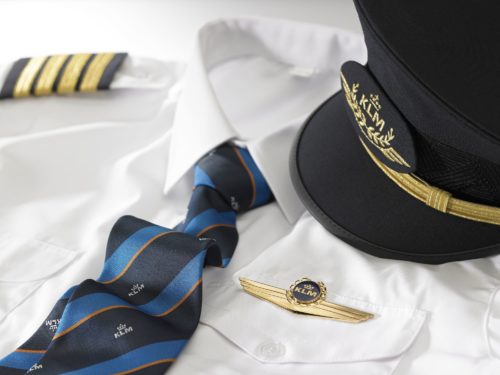 a uniform with a tie and a hat