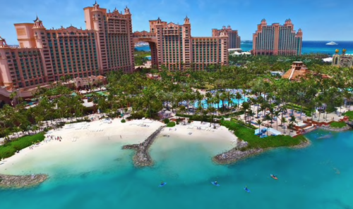 a group of buildings next to a body of water with Atlantis Paradise Island in the background