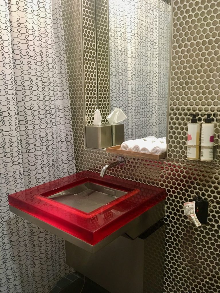 a bathroom sink with red top