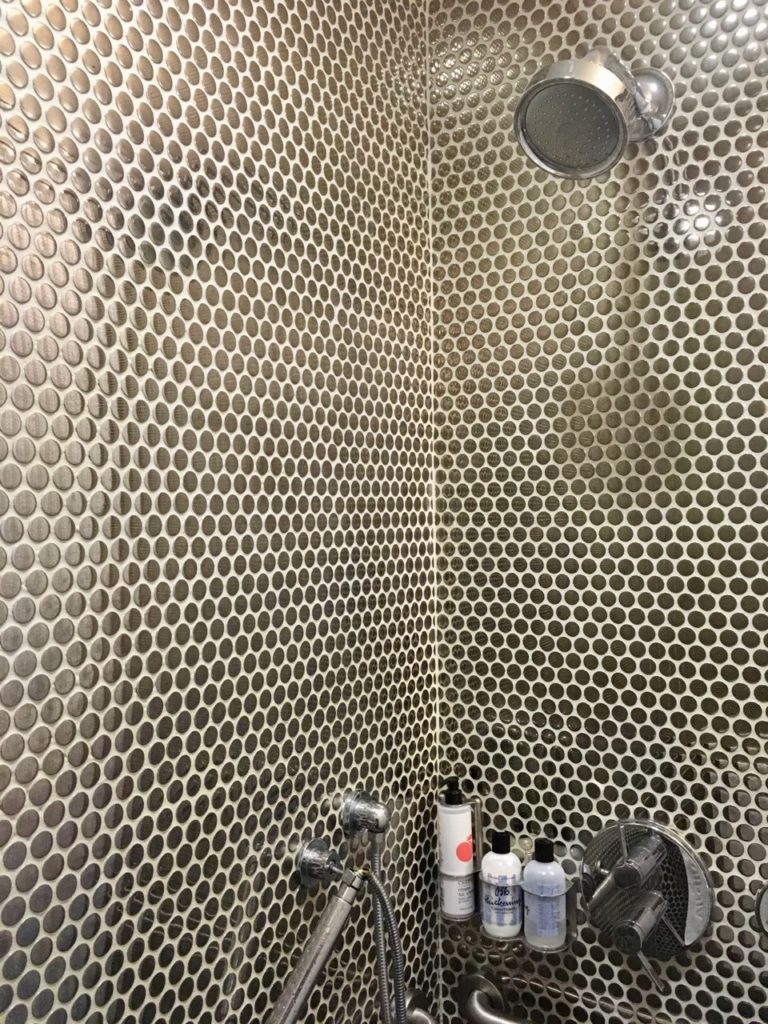 a shower with a shower head and shower head