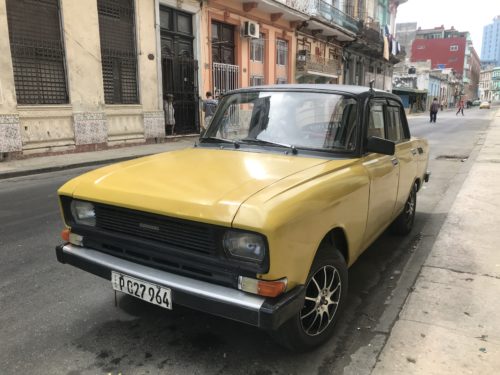 a yellow car parked on a street