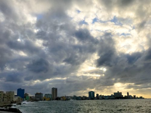 a city skyline with clouds in the sky
