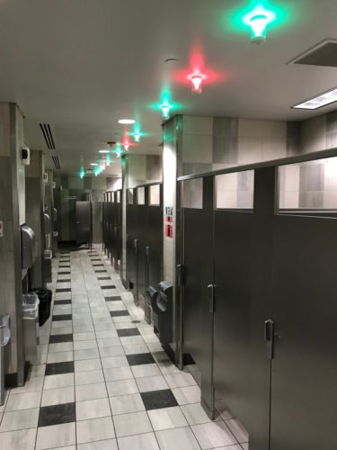 a bathroom with a row of doors
