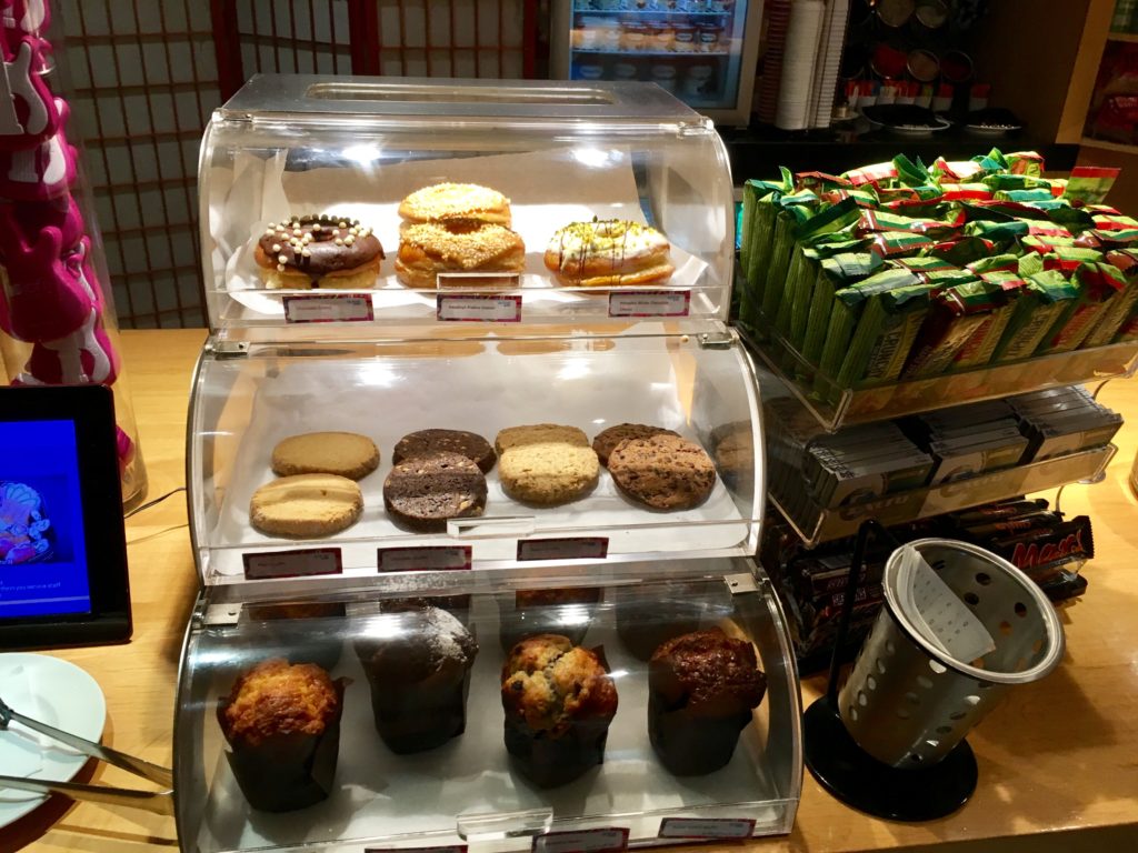 a display case with pastries and cookies