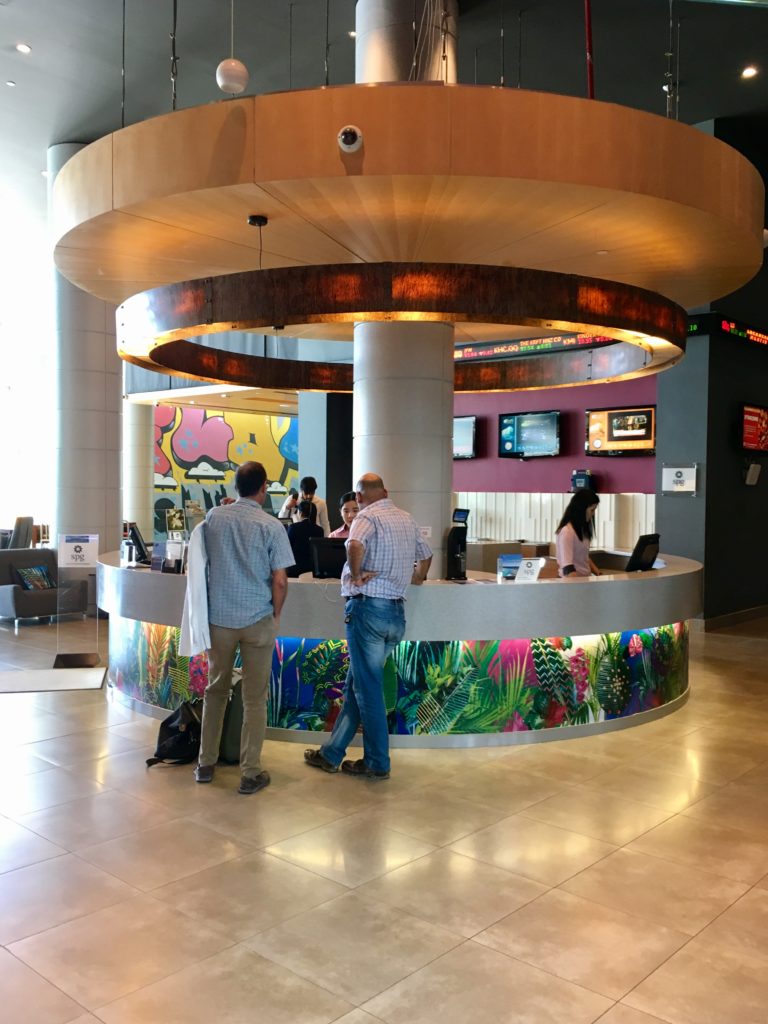 people standing at a counter in a lobby