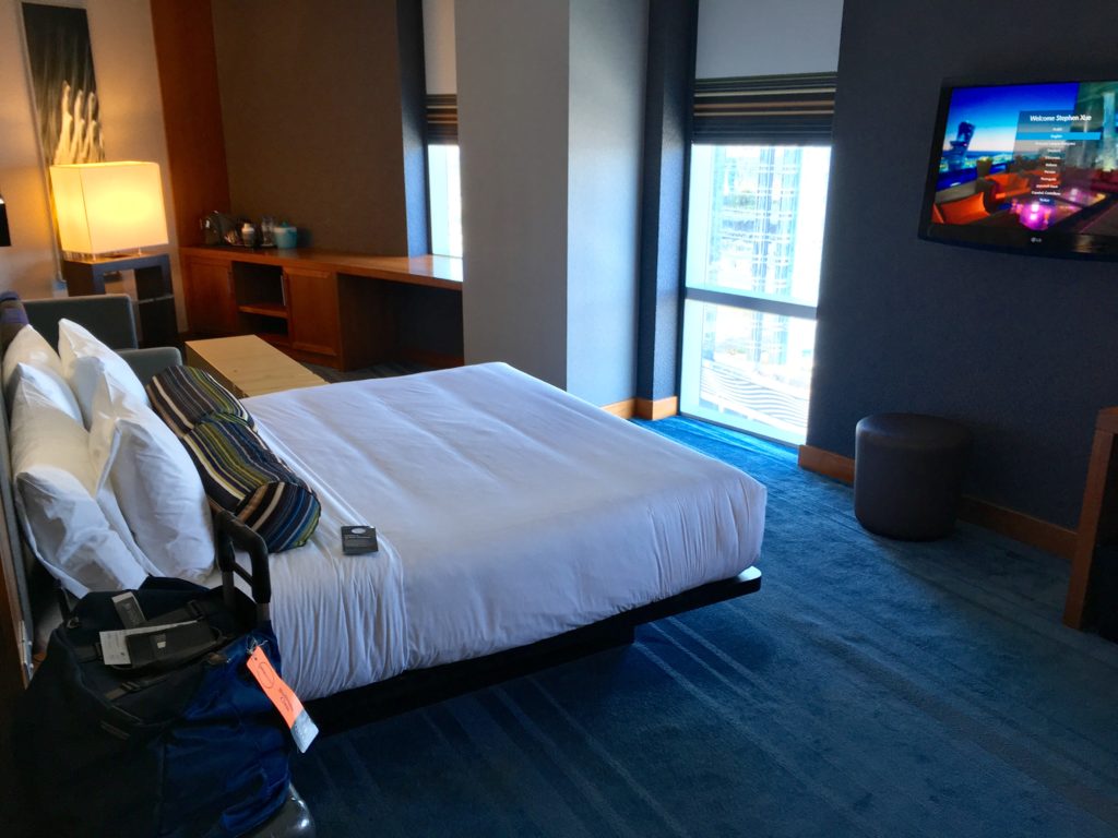 a hotel room with a bed and a television