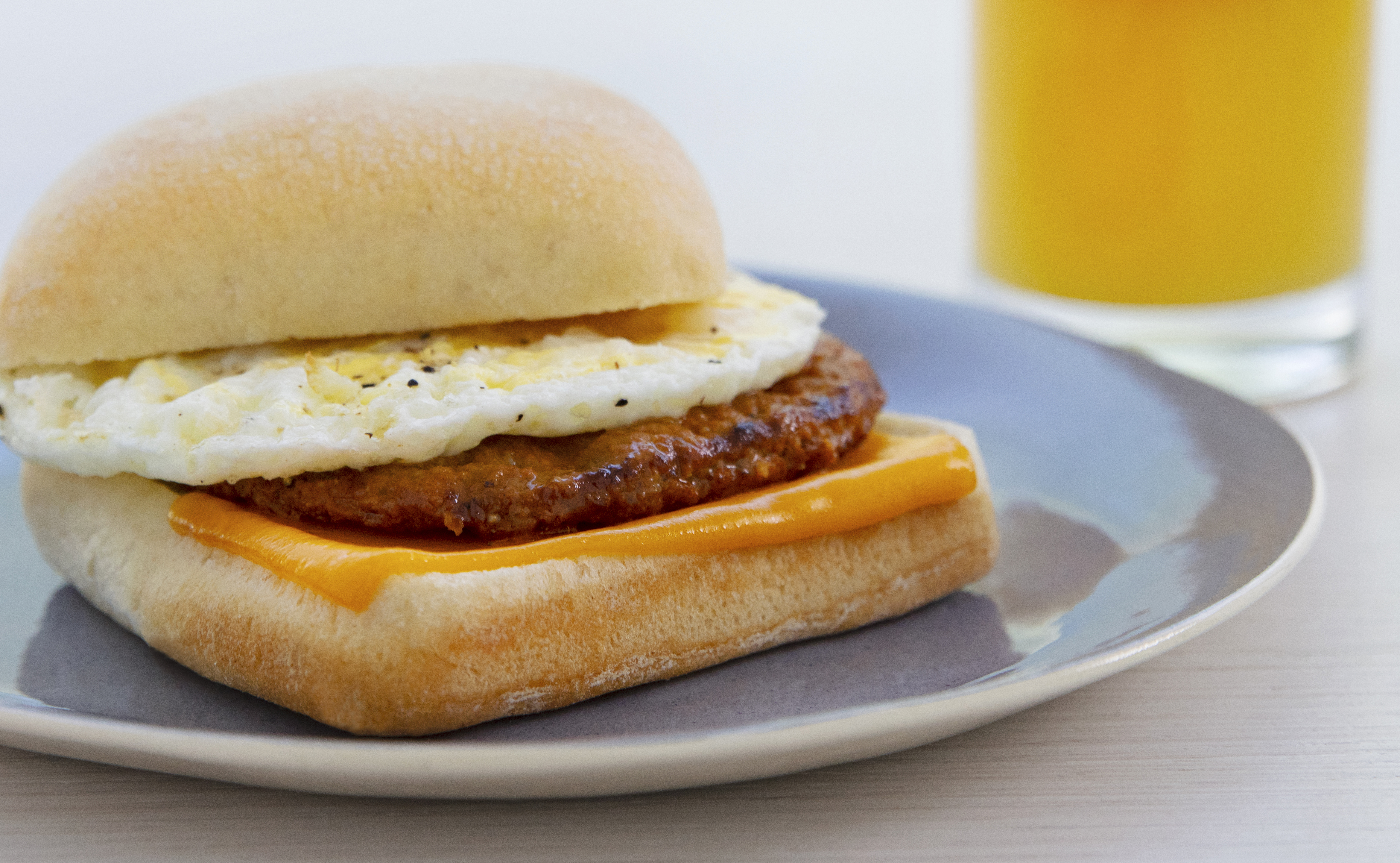 a breakfast sandwich with egg and cheese on a plate