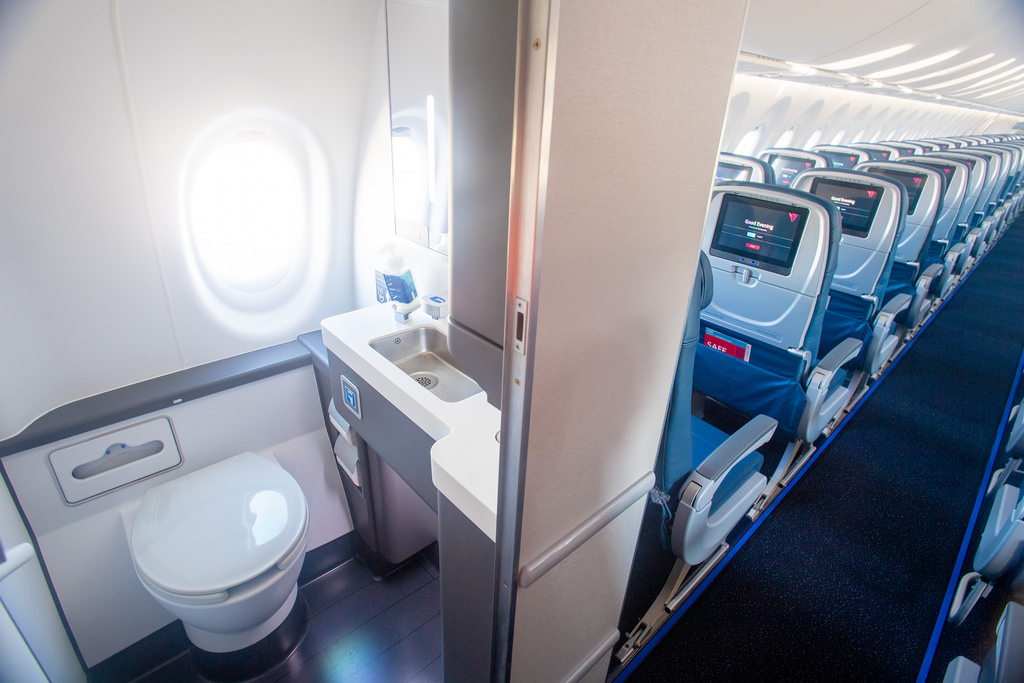 a sink and toilet in an airplane