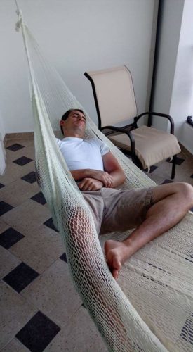 a man sleeping in a hammock