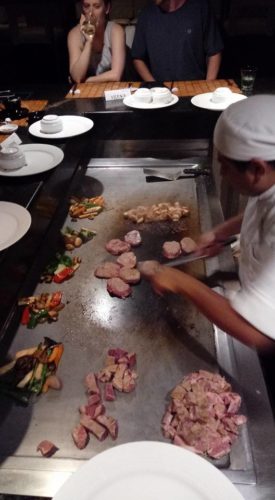 a chef cooking food on a grill