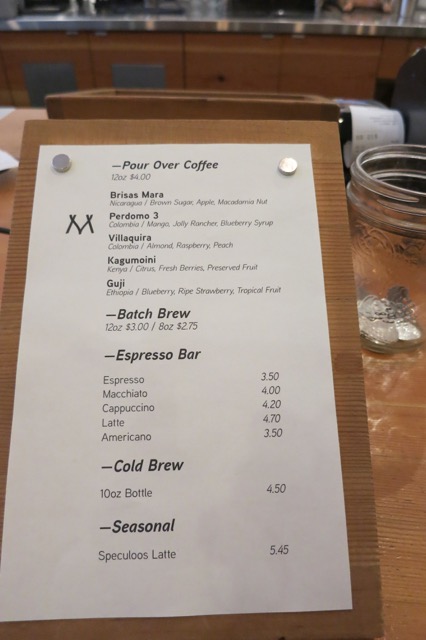 a menu on a wood stand