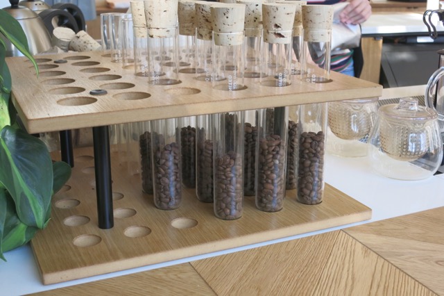 a group of test tubes with coffee beans inside