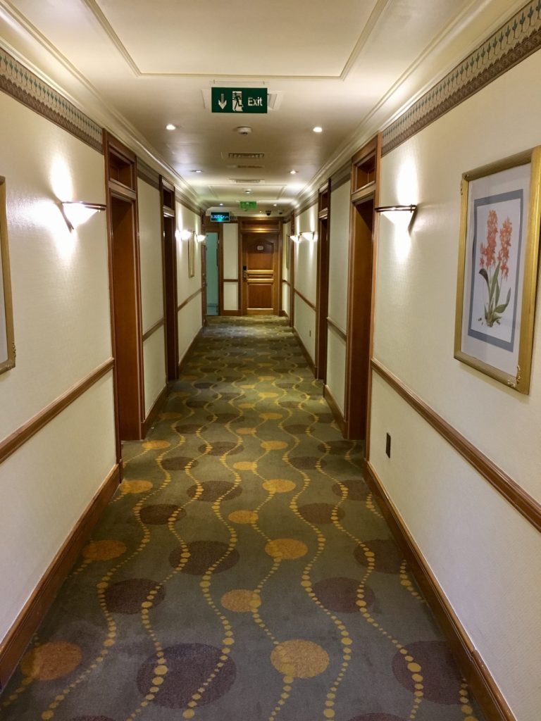 a hallway with a green and yellow carpet