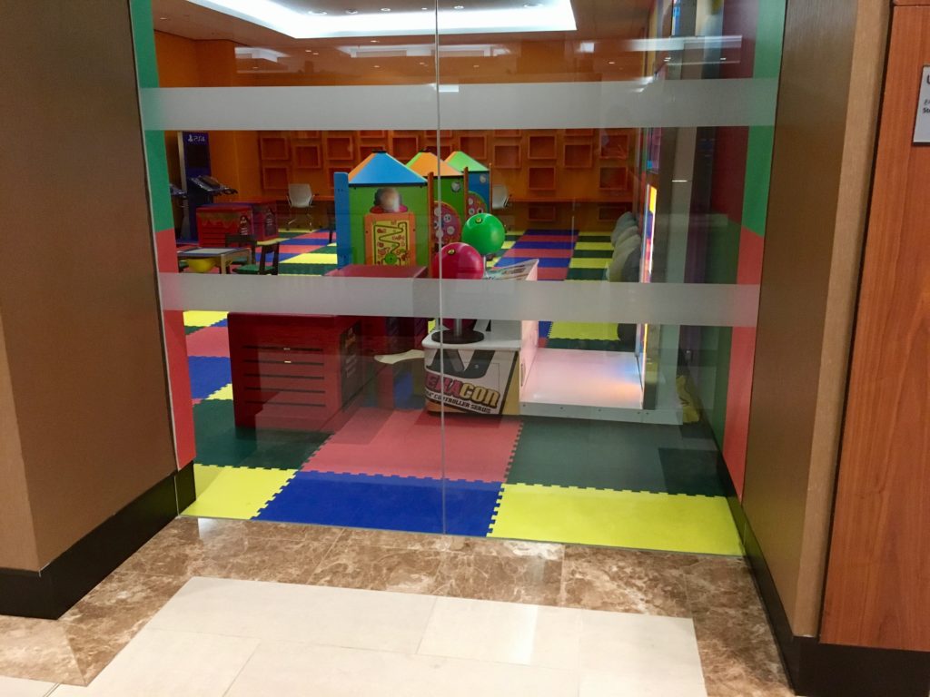 a glass door with a colorful playroom