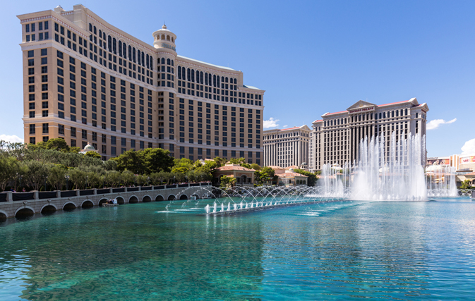 a water fountain in front of a large building with Bellagio in the background