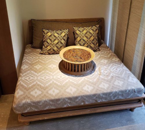 a bed with a bowl on it