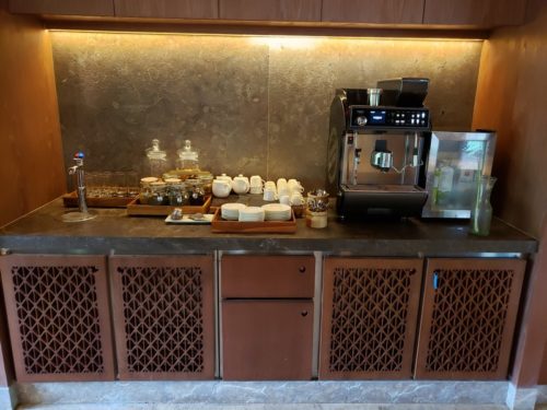 a coffee machine and tea set on a counter