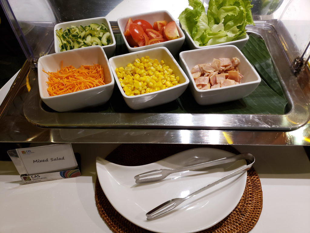 a salad bar with different salads in bowls