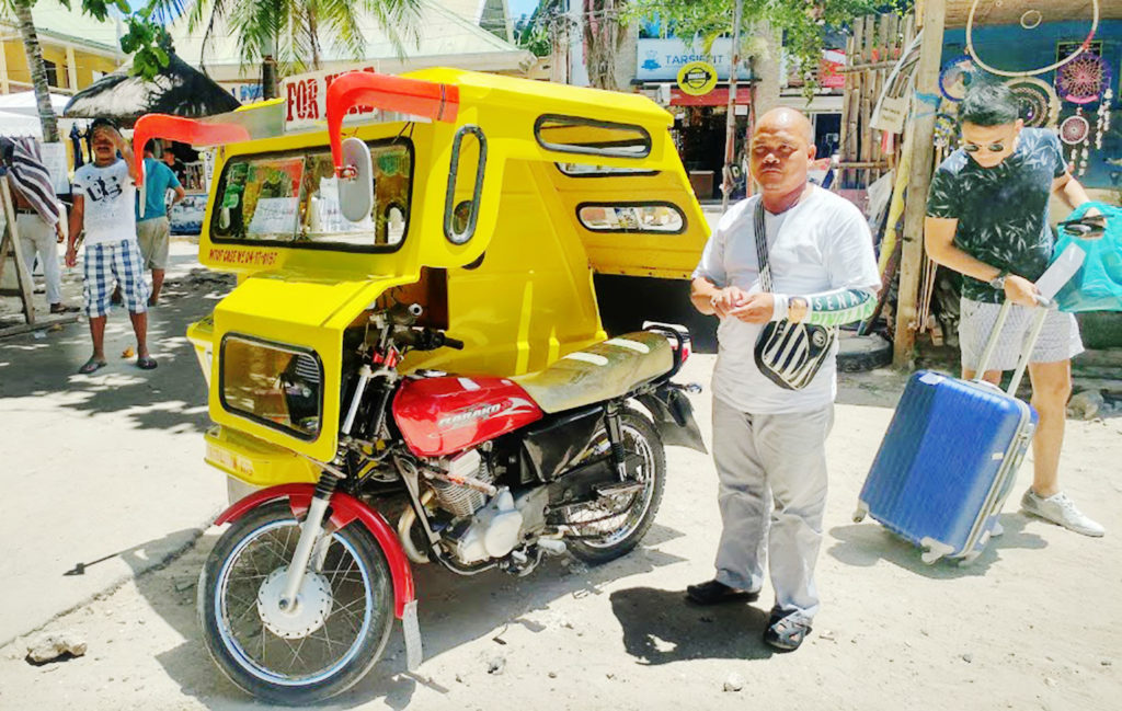 a man standing next to a motorcycle
