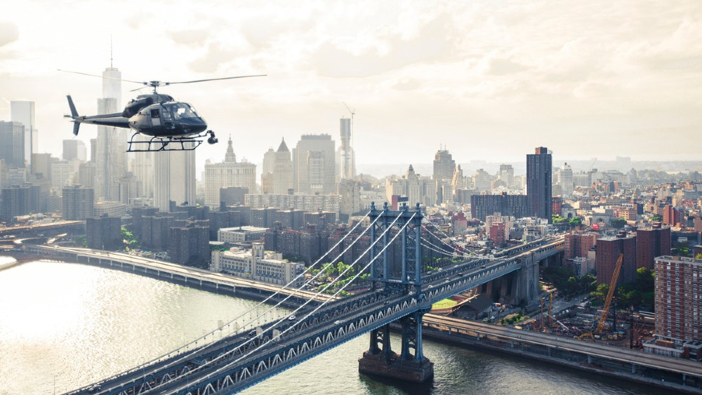 a helicopter flying over a bridge