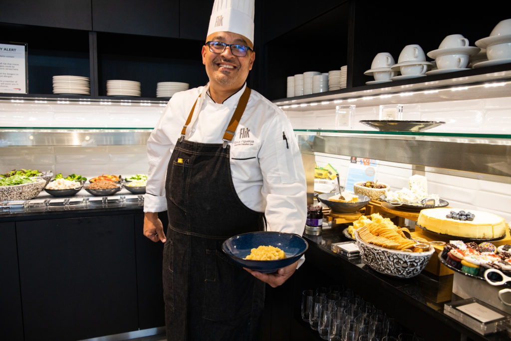 a man in a chef's hat holding a bowl of food