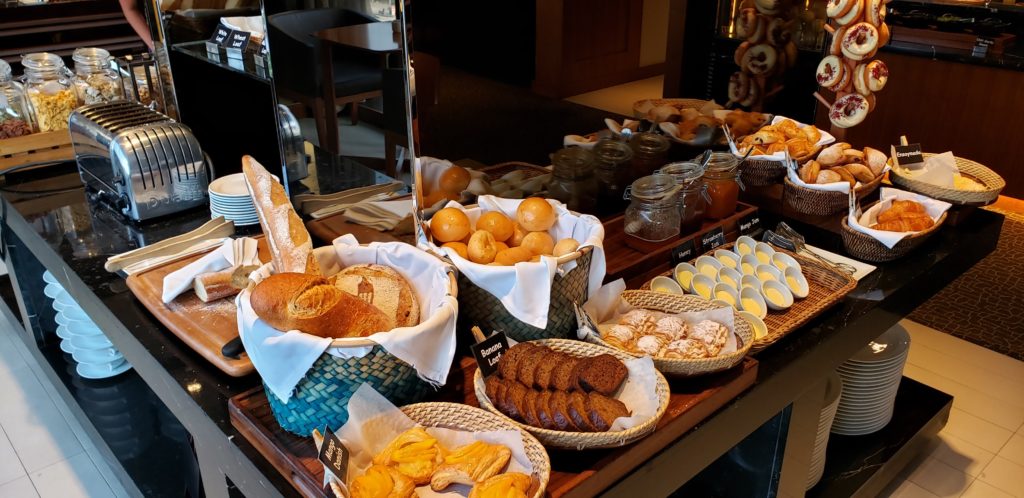 a table with different types of bread and other food