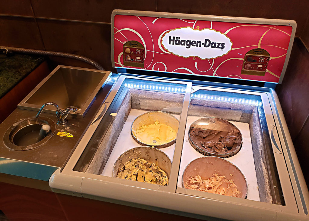 a ice cream machine with bowls of ice cream in it